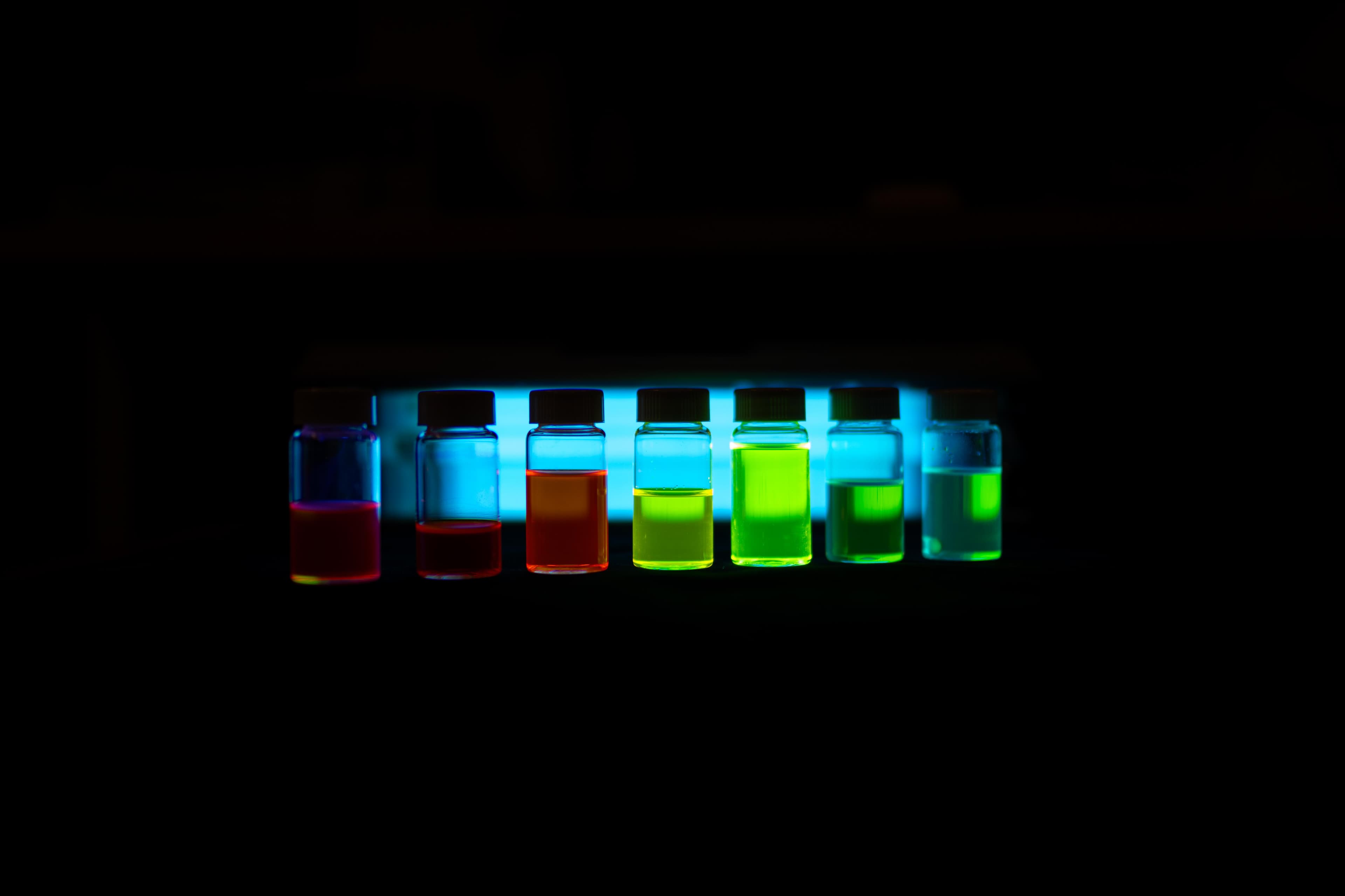 Vials of LEC emitter inks across the visible spectrum