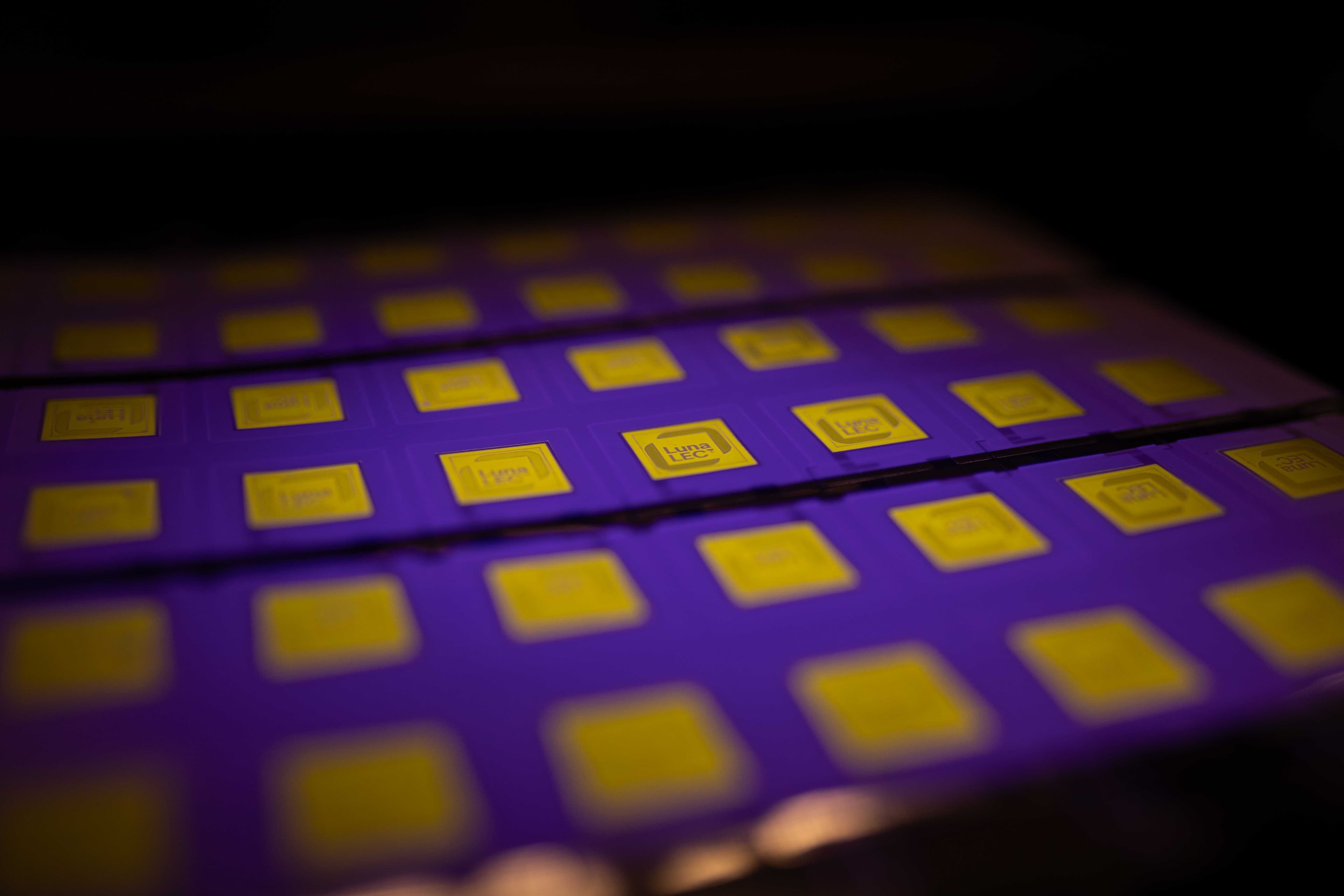 Array of printed LEC tiles under UV illumination